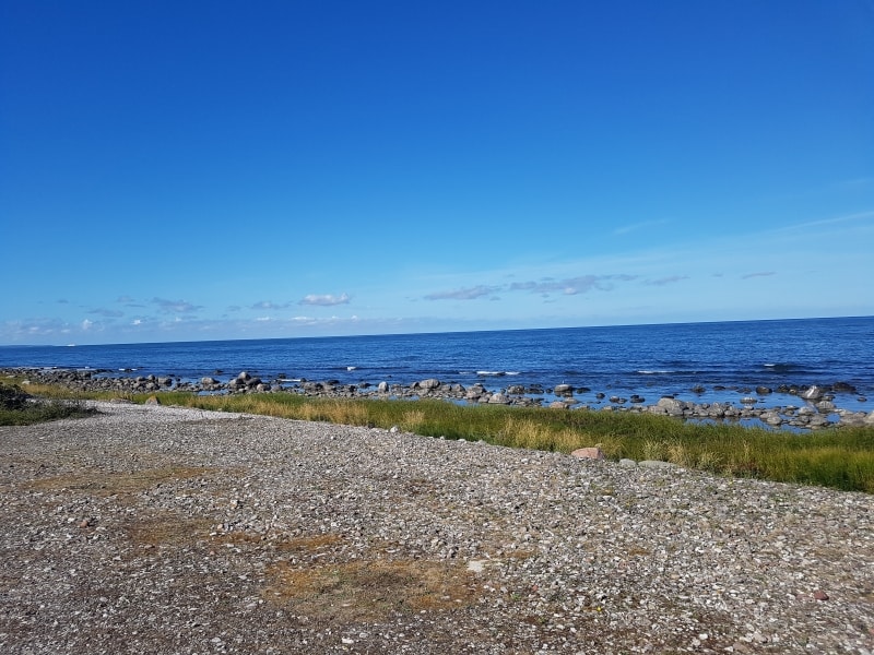 Stenstrand vid Östersjön och blå himmel